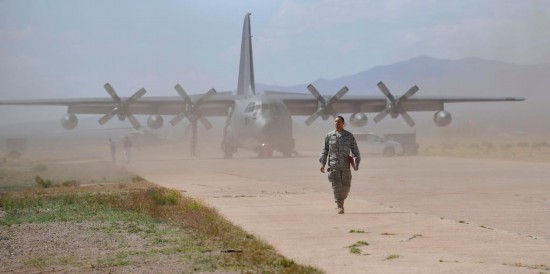 2010年4月21日，在美国亚利桑那州图森以南一处机场举行的2010“雷天使”军事搜救演习中，一名搜救人员走在C-130运输机前。新华社记者张军摄